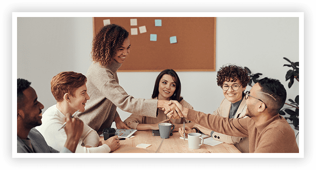 A group of people sitting around a table.