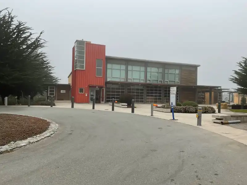 A red building with trees in the background