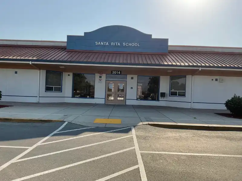 A large building with a parking lot in front of it.