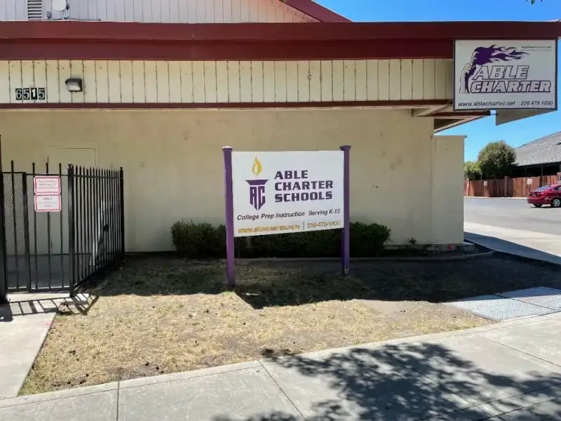 A sign is posted outside of an old christian school.